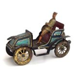 An early tinplate clockwork motocar, with chauffeur, purportedly a Renault