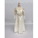 Ivory satin skirt and blouse from 1890s, the blouse has subtle gigot sleeves with ruched band of