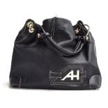Black leather handbag from Anya Hindmarch, the leather handle attached by heavy knobbed metal hooks,