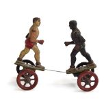 A Gebruder Einfalt, Germany, tinplate clockwork boxing figures on four spoked wheels, the two