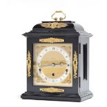 A George III style wooden cased Elliott of London mantle clock with brass detail. 8-day lever