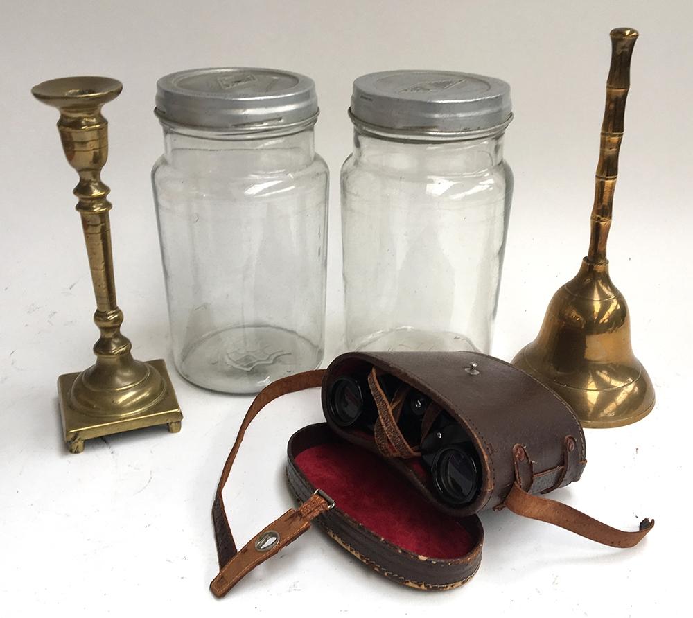 Two vintage glass jars, a brass bell with bamboo style handle, brass candlestick, and a pair of