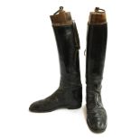A pair of lady's black leather hunting boots with trees, approximately size 6