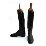 A pair of gent's black hunting boots, some patching, approximately size 8.5, with wooden trees