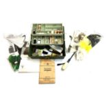 A three tier tackle box containing a large quantity of fly tying materials and equipment,