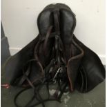 An English cut leather hunting saddle; together with double bridle in serviceable condition