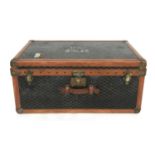 A late 19th century Malles Goyard canvas, tan leather, metal and studded travelling trunk, having