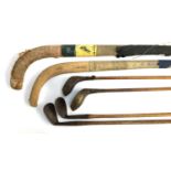 Four vintage golf clubs, one Ford, one Mashi, together with two vintage hockey sticks by Wilton of