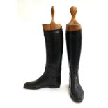 A pair of black lady's hunting boots with wooden trees