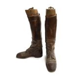 A pair of gent's brown field boots with wooden trees, approximately size 8