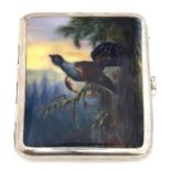 A silver cigarette case, the top enamelled with a Capercaillie in a highland landscape, 9.5x8.5cm