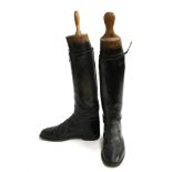 A pair of gent's black hunting boots, with garter straps, approximately size 8.5, with wooden trees