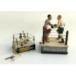 Boxing interest, a cast iron novelty 'Boxing Bank', 21cmH; together with 'Slugger Champions' wind up