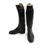 A pair of ladies black hunting boots, approximately size 7, with wooden trees