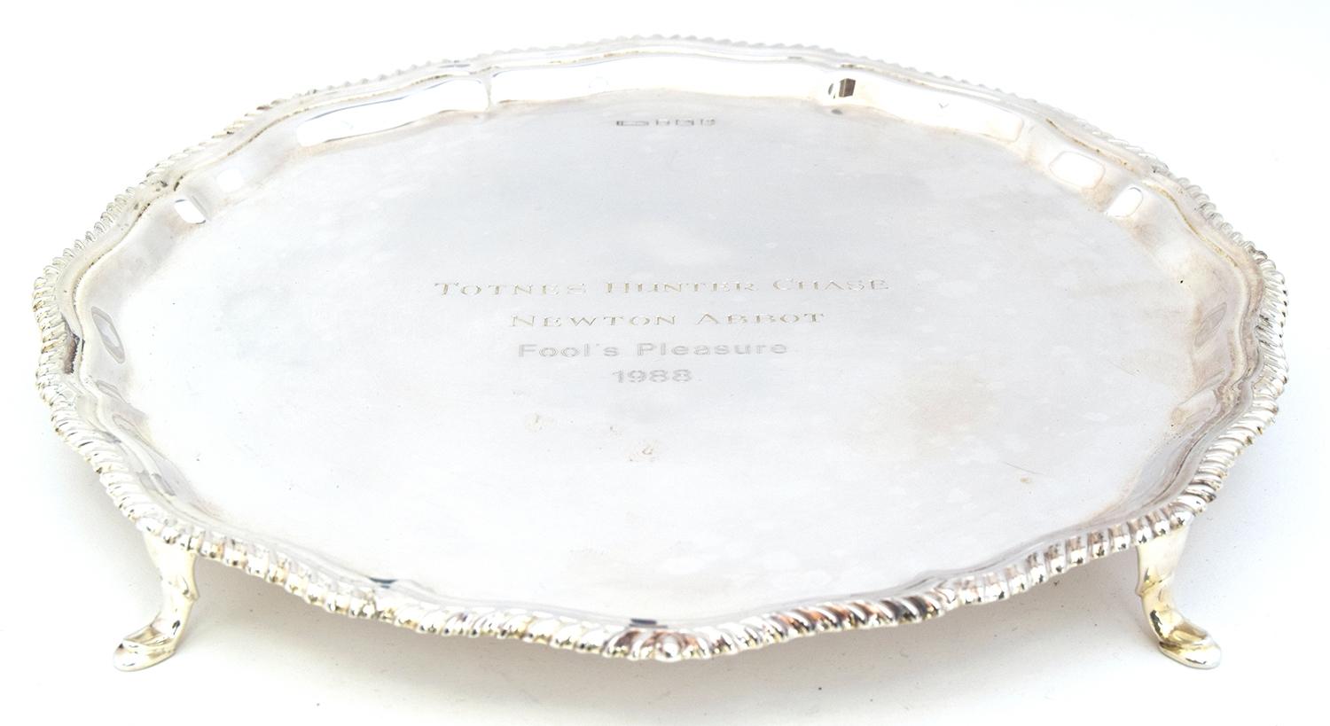 A silver platter with gadrooned edge, Sheffield 1960, raised on four hoof feet, 16.4oz