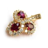 An 18ct gold Graff pendant/brooch set with diamonds and rubies in three cluster heads. Unmarked