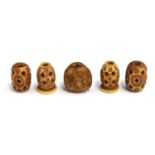 An Adjume bead depicting a face, together with four other beads