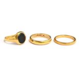 A 22ct gold wedding band, size O, 4.4g; a gold band size O (marks rubbed), 3.1g; and a yellow