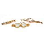 Three brooches, one yellow metal set with two aquamarine stones, gross weight 10g, further 9ct