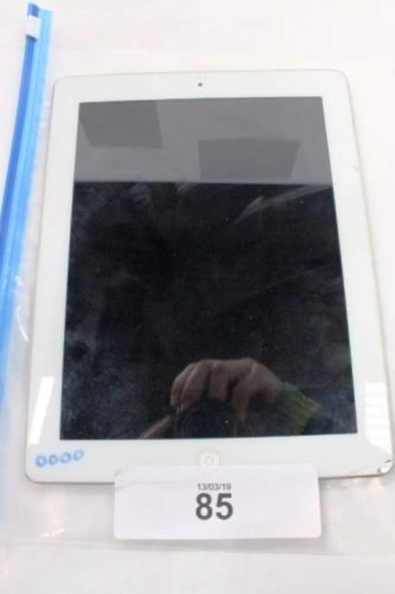 A silver Apple tablet, model A1460, factory reset, powers on, no accessories, damaged glass lower