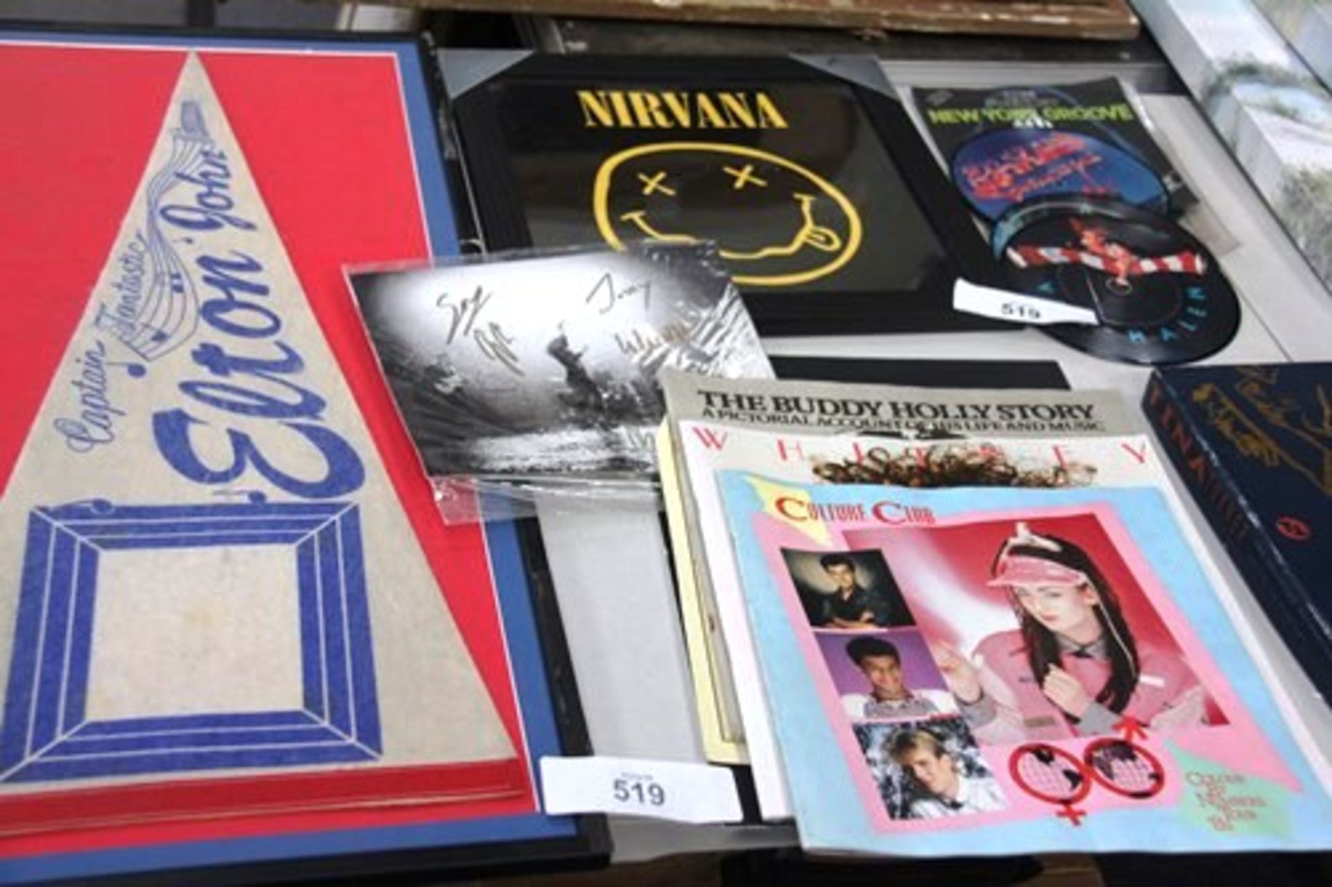 Items of memorabilia comprising Captain Fantastic Elton John banner and a print of a Nirvana