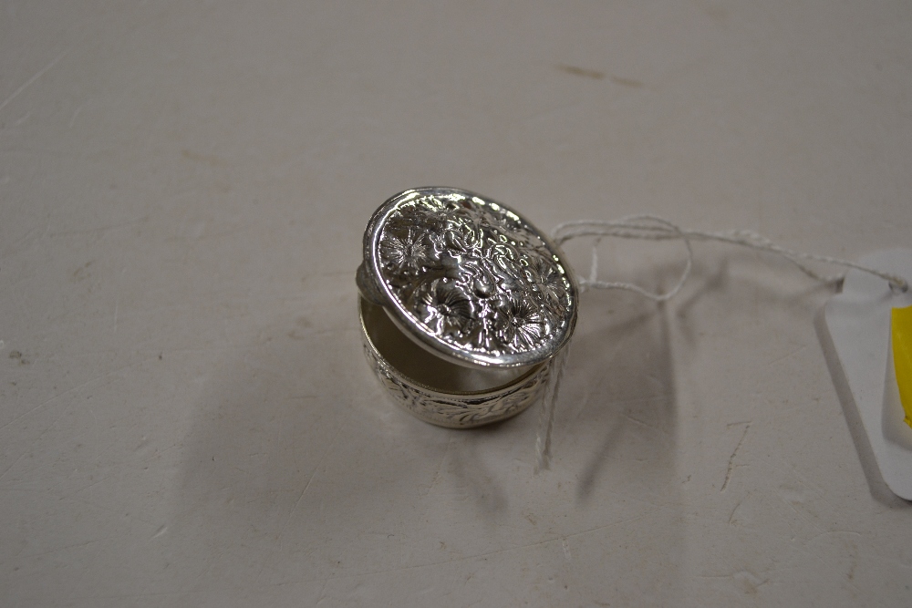 A silver embossed circular pill box, stamped 925