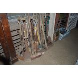 A large quantity of long handled gardening tools