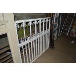 A pair of white painted metal gates