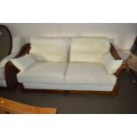 A wooden framed and cane two seater settee