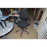 A black upholstered swivel office chair