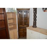An oak and leaded glazed corner cabinet