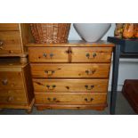 A modern pine chest fitted two short over three lo