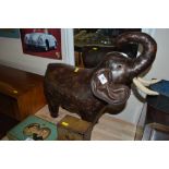 An elephant brown leather door stop