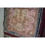 An approx 4'7" x 3" pink and brown wool rug