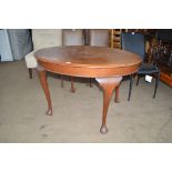 A mahogany table raised on cabriolet supports