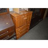 A modern pine tall boy fitted three drawers