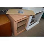 A glass fronted cabinet together with a shelf