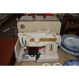 A Singer sewing machine in carrying case sold as c