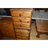 A pair of pine bedside chests fitted three drawers