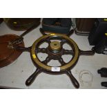 A small brass and wood ships wheel