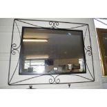 A wrought iron framed mirror