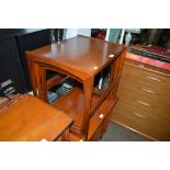 A nest of three teak occasional tables