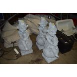 Three concrete garden gnomes