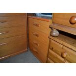 A teak effect bedside chest fitted four drawers