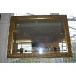 A large gilt framed bevel edged mirror