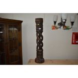 A large hardwood oak and twist candle stand