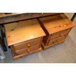 A pair of pine two drawer bedside chests