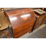 An Edwardian mahogany and inlaid three drawer bure