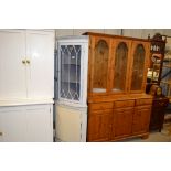 A painted and glazed corner cabinet