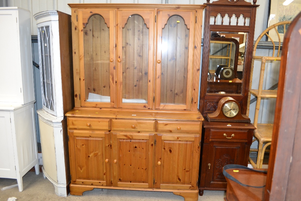 A modern pine and glazed three drawer dresser